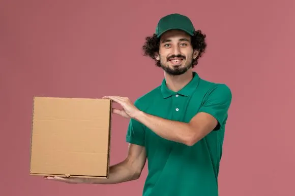 Male movers and Packers in Andheri East in green tshirt holding Box