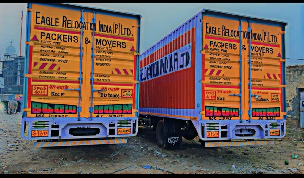 Packers and Movers in Panipat Team standing in front of moving trucks