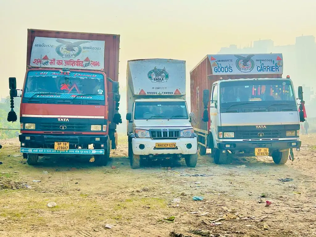 Eagle Movers and packers in Noida Sector 143 trucks are parked in ground 